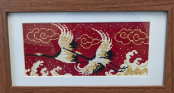 Two Cranes Flying Across Red Sky